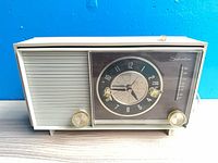 Front view of Silvertone clock radio showing speaker grille, clock, tuning window, and knobs