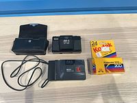 Full lot overview showing two Ricoh cameras, hard case and two Kodak film boxes
