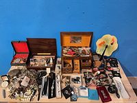 overview of table with jewelry boxes and assorted jewelry