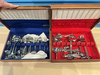 Both wooden flatware cases open displaying contents