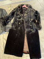 dark fur coat laid flat