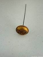 Obverse of gilt brass button showing crown, strap text and "1"