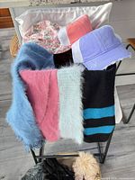 Hats and scarves draped over chair