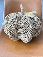 Front view of woven pumpkin showing stem and overall shape