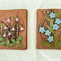 Two ceramic wall plaques with floral reliefs