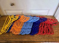 Assorted coloured plastic children's hangers stacked