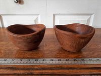 Front view of both teak bowls side by side on ruler