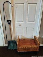 Shepherd hook, snow shovel and wicker bench together for scale