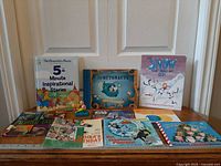 All eight books arranged front and back rows on table