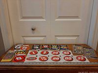 Overall view of packaged NASCAR decals and bottle-cap decals laid out on table