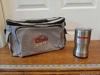 Cooler and tumbler side by side with ruler for scale