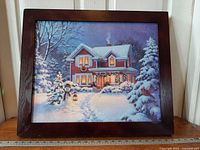 Framed winter scene art with ruler for scale