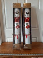 Two boxed Life at Home giant crackers standing side by side