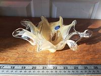 Top view of Arte Murano cream swirl glass bowl with label visible