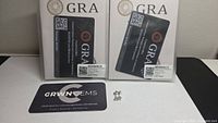 Front view of GRA certification cards, GRWN GEMS card, and stud earrings