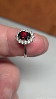 Front view showing oval garnet and CZ halo