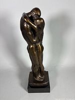 Full view of bronze-tone couple sculpture, front