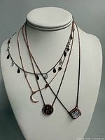 All four necklaces layered on bust