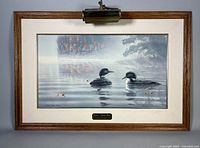 Full view of framed Marc Barrie lithograph with light and plaque