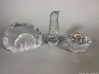 Group view of three Swedish crystal paperweights