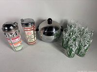 Complete lot: two cocktail shakers, eight floral glasses, West Bend Penguin server