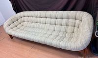 Front angled view of teak scoop sofa