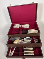 Full view of three-drawer chest open showing flatware arrangement