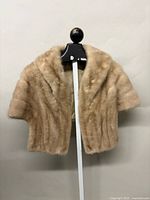 Full view of mink fur stole on hanger