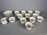 Grouping of teacups, saucers, sugar bowl and creamer