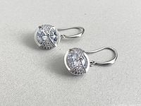 Front view of both sterling silver earrings showing clear stones and pavé accents