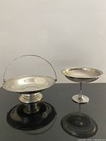 Both silverplate pieces side by side