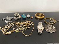 Full lot overview showing all jewelry pieces on black surface