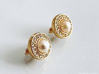 front view showing faux pearl centers and rhinestone halo