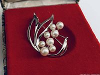 Front view of sterling silver brooch with eight pearls