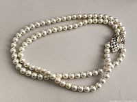 Full view of double strand faux pearl necklace arranged in oval