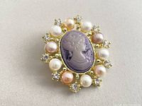 Front view showing purple cameo, pearl and rhinestone arrangement