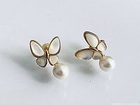front view of both earrings showing butterfly design and pearls
