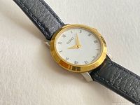 Front angled view showing dial, bezel, and leather strap