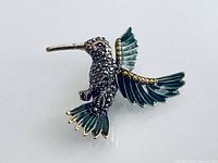 Front view showing full hummingbird design, enamel wings and rhinestone body