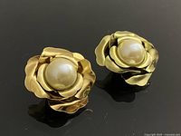 Front view of both rose clip-on earrings showing faux pearl centres and gold-tone petals