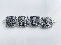 Full view of bracelet showing four relief panels