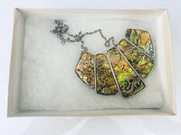 Full necklace in box showing five ammolite panels and chain