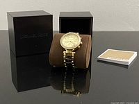 Watch on cushion with presentation box, outer box and booklet