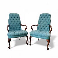 Two matching Queen Anne style armchairs side by side showing overall condition, upholstery, and wood legs
