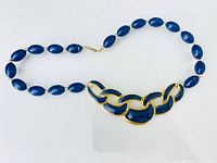 Full view of necklace showing chain-link enamel centerpiece and bead strand