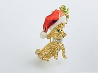 Front view of gold-tone poodle brooch with Santa hat and rhinestone details