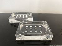 Two clear acrylic soap dishes top view