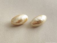 front view of both faux pearl oval earrings