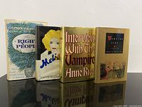 Front view of all four first edition hardcovers standing side by side