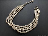 Necklace fully laid out showing four strands and clasp